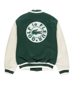 Tyler the Creator green varsity jacket and fur hat giving a speech on stage. Golf le Fleur style.