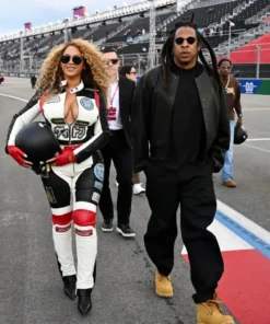 Beyoncé holds a helmet walking the grid in a Louis vuitton Las Vegas race grid walk track suit.