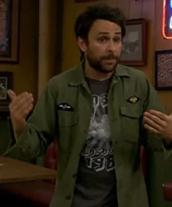 Charlie Day green jacket outfit from It's Always Sunny in Philadelphia. Close-up of charlie jacket on sunny in philadelphia with embroidered patches on the pockets.