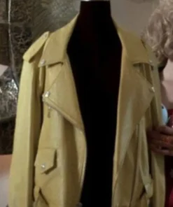 Front view of a yellow leather motorcycle jacket on a mannequin, featuring wide lapels, silver snaps, and an asymmetrical zipper, capturing the 90s Buffy style.