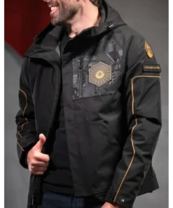 Man smiling while wearing the black and gold Destiny 2 Salvation's Edge Jacket. Details of the front design are visible. Final Shape Raid Jacket.