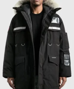 Front view of a men’s black parka jacket with fur-trim hood, reflective panels, and multiple utility pockets.