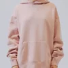 Front view of the Pacsun Essentials Hoodie Peach on a person, highlighting the relaxed fit. Ideal for an essentials hoodie outfit.