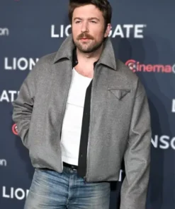 Brandon Sklenar wears The Housemaid 2025 Andrew Winchester jacket. This premium grey wool jacket features a distinct triangular chest pocket.