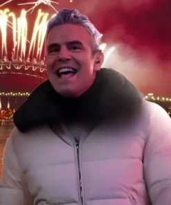 Andy Cohen wearing a white and navy reversible quilted down jacket with zip front and stand collar on New Year’s Eve