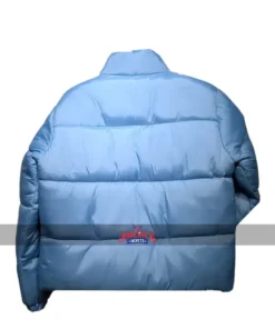 Back view of the light blue Andy Cohen Jacket, a stylish puffer jacket featuring horizontal quilting and a high collar for a trendy winter look.