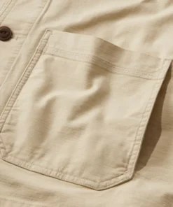 Close-up of a pocket on this beige lightweight cotton jacket for men, showing the durable stitching and premium textured cotton jacket for men material.
