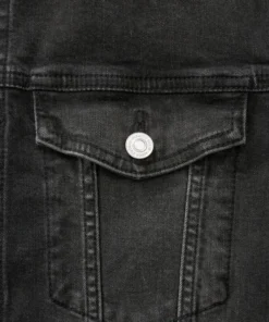 Detailed view of a chest pocket on a black denim jacket, showing durable stitching and silver buttons for a premium black denim style jacket.