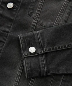 Close-up of the buttoned cuff on a jean jacket black sleeve, showcasing the quality finish of this essential men black denim jacket piece.