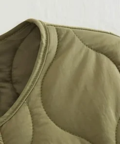 Close-up detail of the Crew Neck Womens Quilted Green Jacket, highlighting the high-quality stitching, durable fabric, and clean neckline finish.