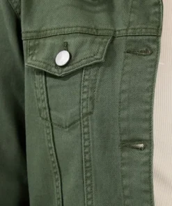 Close-up of a green denim jacket showing high-quality stitching, metal button closure on the chest pocket, and durable green jacket denim fabric.