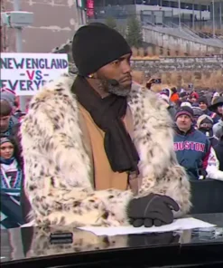 Randy Moss wears a spotted fur coat during the Patriots vs Texans broadcast, featuring the Randy Moss Patriots Texans fur coat style.