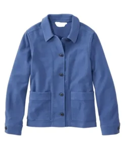 A woman wearing a blue stretch barn jacket by America Jackets, front view showing the collar and pockets.