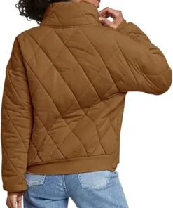 Rear view of a model wearing the Brown Dolman Quilted Jacket showcasing the relaxed fit, quilted back panel, and comfortable ribbed hemline.