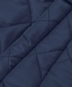 Close-up detail of a blue quilted jacket womens style, highlighting the high-quality navy blue cotton fabric and precise diamond quilting texture.