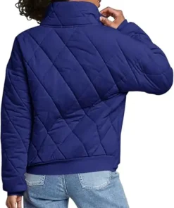 Rear view of a woman wearing a Navy Dolman Quilted Jacket featuring a high collar, oversized fit, and classic diamond-shaped quilted embroidery.