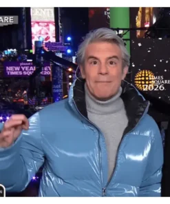 Andy Cohen blue puffer jacket worn unzipped to show the inner lining.