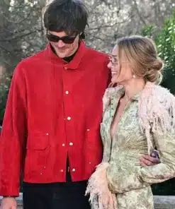 Margot Robbie wears a John Galliano Long Trim Coat with Jacob Elordi during the Wuthering Heights London tour.