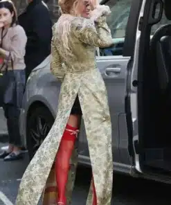 Rear view of the John Galliano feather collar long coat on Margot Robbie as she arrives at the London photocall event.