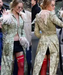 Detail view of Margot Robbie's long coat London photocall look by John Galliano, showing the floral brocade and feathered trim.