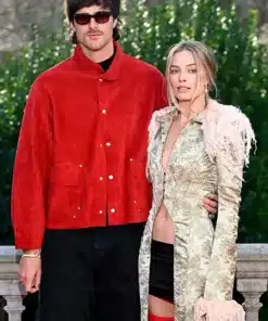 Margot Robbie and Jacob Elordi at a London photocall where she wears an archival John Galliano coat with feather trim.