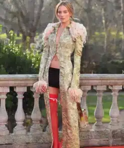 Actress Margot Robbie in her Wuthering Heights press tour coat by John Galliano, showcasing the intricate long trim coat design.