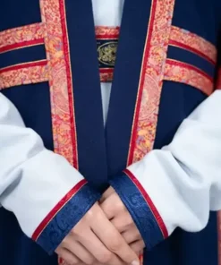 Detail of the mongolia olympics 2026 opening ceremony womens outfit, showing the belted deel waist and decorative red silk borders on the sleeves.