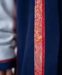 Close-up of the Mongolia opening ceremony uniform womens deel 2026, featuring vibrant red and orange silk embroidery along the robe’s edge.