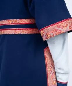 Detailed view of the winter games 2026 team mongolia womens uniform, showing the red and gold patterned trim on the navy blue traditional deel.