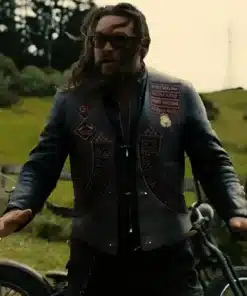 Jason Momoa wearing the wrecking crew jason momoa leather vest with custom biker patches and sunglasses while standing outdoors.