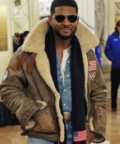 Olympics 2026 Usher Shearling Leather Jacket worn as a complete outfit with denim jeans and a dark scarf.